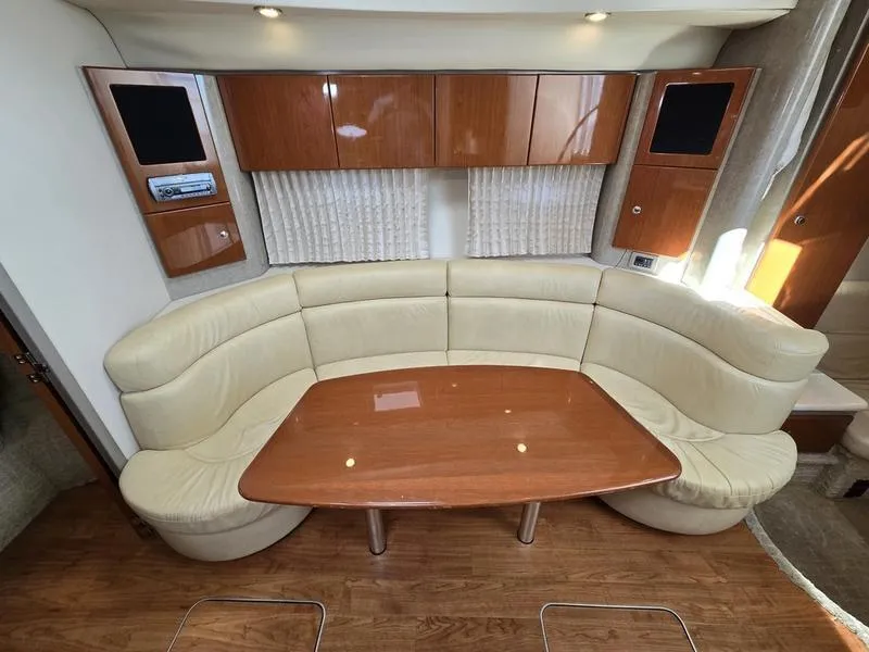 Slide: The Image of 2008 Formula 37 PC yacht interior with curved seating and wooden table. - 38