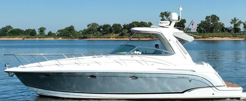 Slide: The Image of 2008 Formula 37 PC yacht cruising on a calm lake with a clear blue sky. - 6