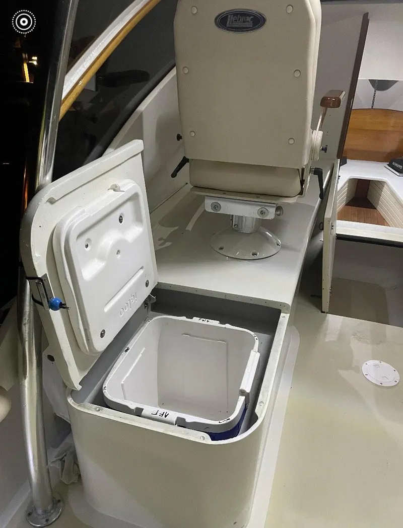 Slide: The Image of 2011 Custom Carolina Express boat interior with open storage compartment and seating. - 7