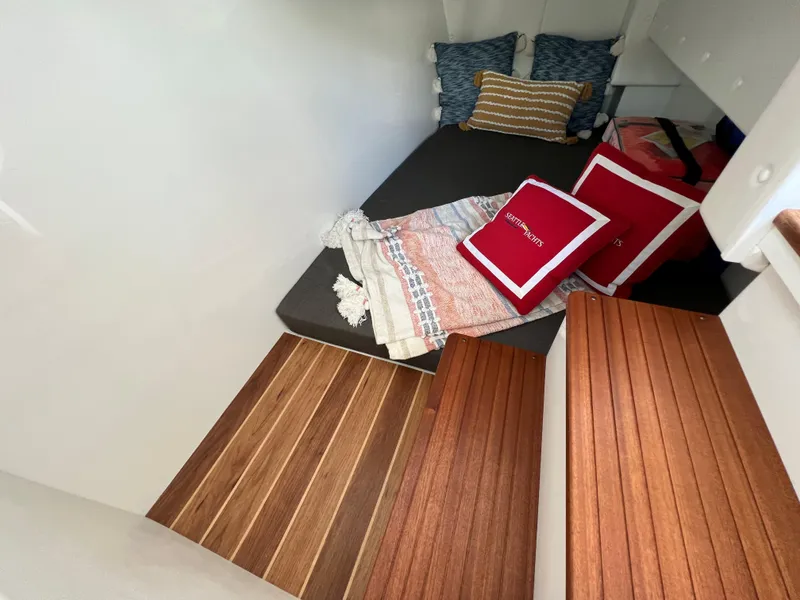 Slide: The Image of Cozy interior of 2022 Ocean Sport 30 Roamer with cushions and wooden steps. - 10