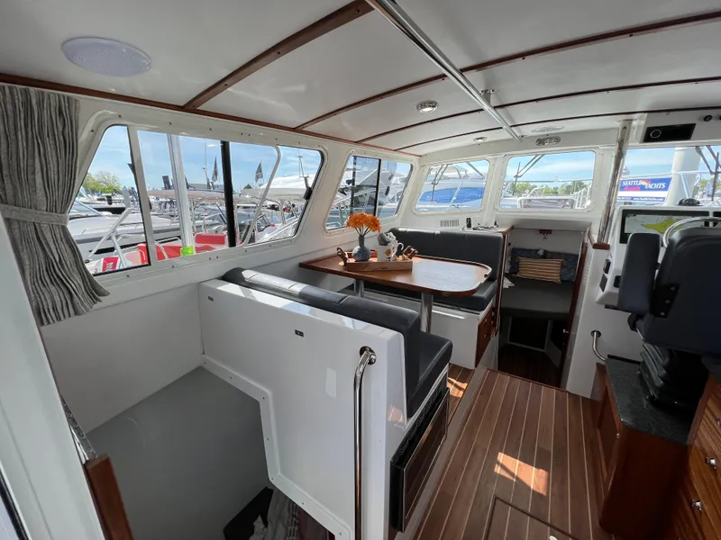 Slide: The Image of Interior of 2022 Ocean Sport 30 Roamer boat with seating and dining area. - 11