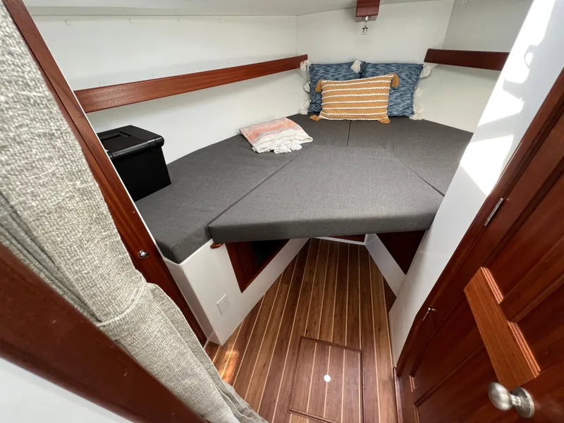 Slide: The Image of 2022 Ocean Sport 30 Roamer cabin with cozy bed and wooden flooring. - 12