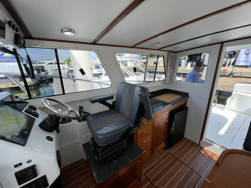 Slide: The Image of Interior of 2022 Ocean Sport 30 Roamer boat with helm and seating area. - 15