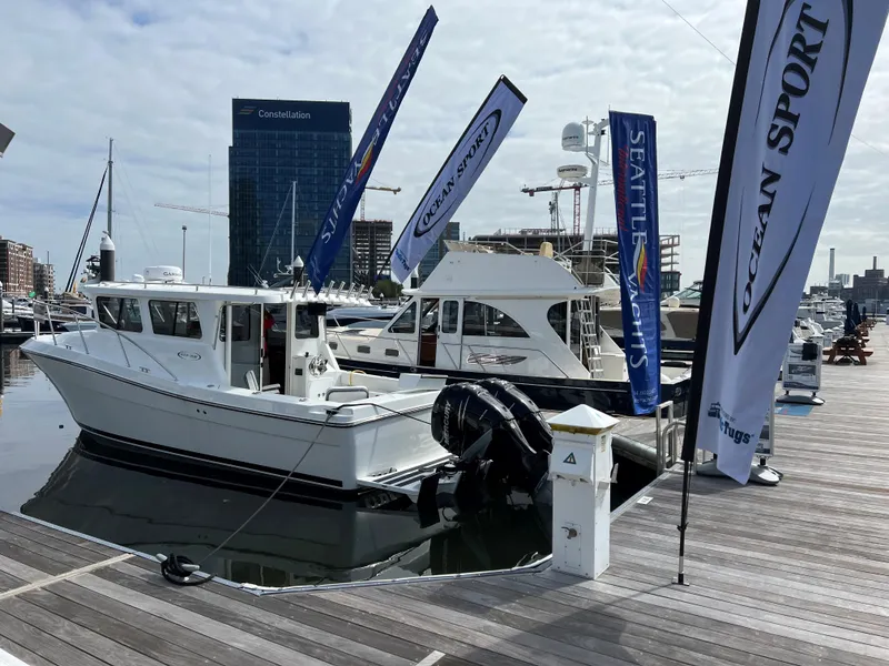 Slide: The Image of 2022 Ocean Sport 30 Roamer docked at marina with promotional flags. - 3