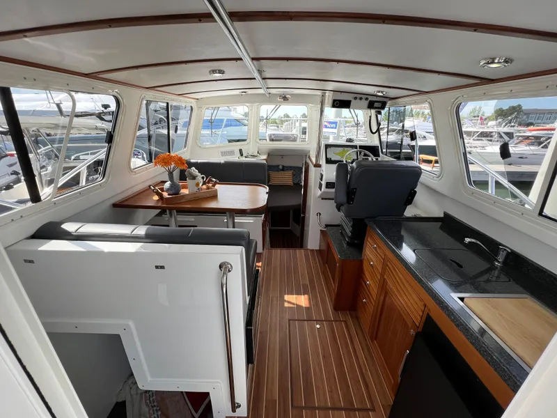 Slide: The Image of Interior of 2022 Ocean Sport 30 Roamer boat with modern kitchen and seating area. - 8