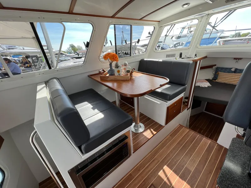 Slide: The Image of Interior of 2022 Ocean Sport 30 Roamer boat with seating and table. - 9