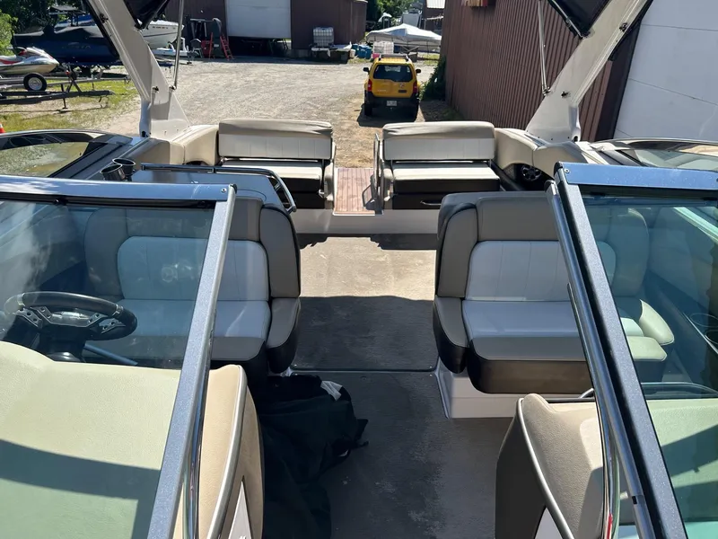 Slide: The Image of 2013 Regal 3200 Bowrider interior with seating and open deck view. - 11