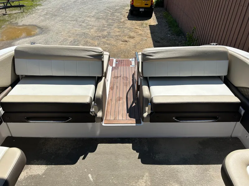 Slide: The Image of 2013 Regal 3200 Bowrider boat interior with cushioned seating and wooden flooring. - 13