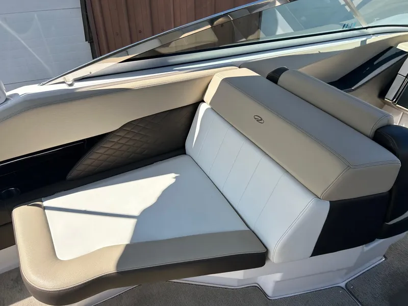 Slide: The Image of 2013 Regal 3200 Bowrider interior seating with beige and white upholstery. - 14