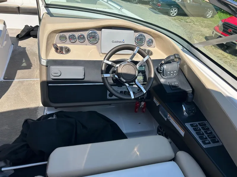 Slide: The Image of 2013 Regal 3200 Bowrider dashboard with Garmin navigation and modern controls. - 15