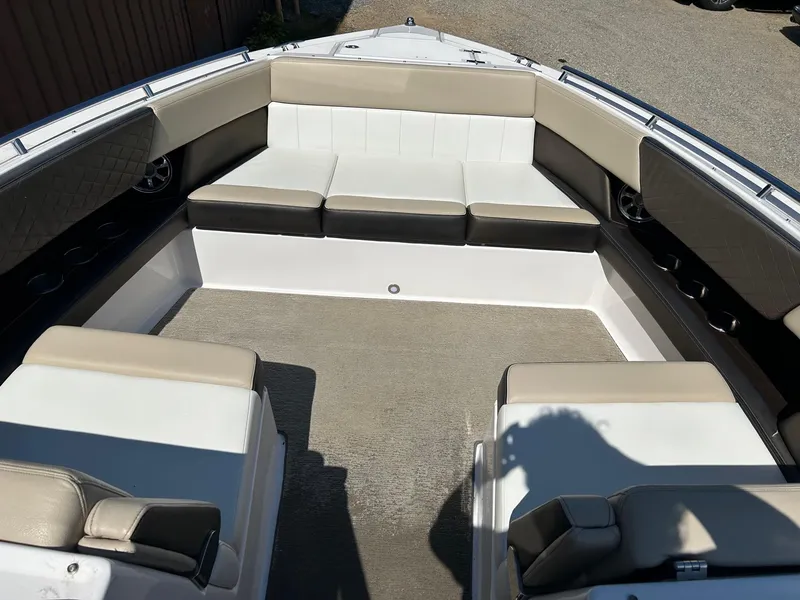 Slide: The Image of 2013 Regal 3200 Bowrider boat interior with beige and white seating. - 16
