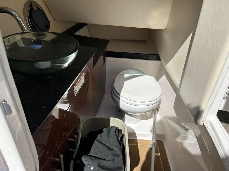 Slide: The Image of 2013 Regal 3200 Bowrider interior with sink and toilet. - 17