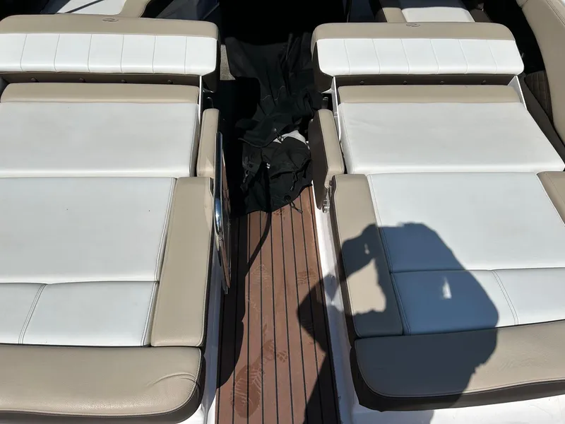 Slide: The Image of 2013 Regal 3200 Bowrider boat interior with white and beige seating. - 18
