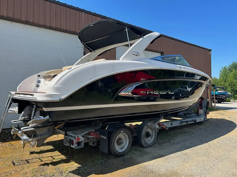 Slide: The Image of 2013 Regal 3200 Bowrider boat on trailer, parked outdoors. - 2