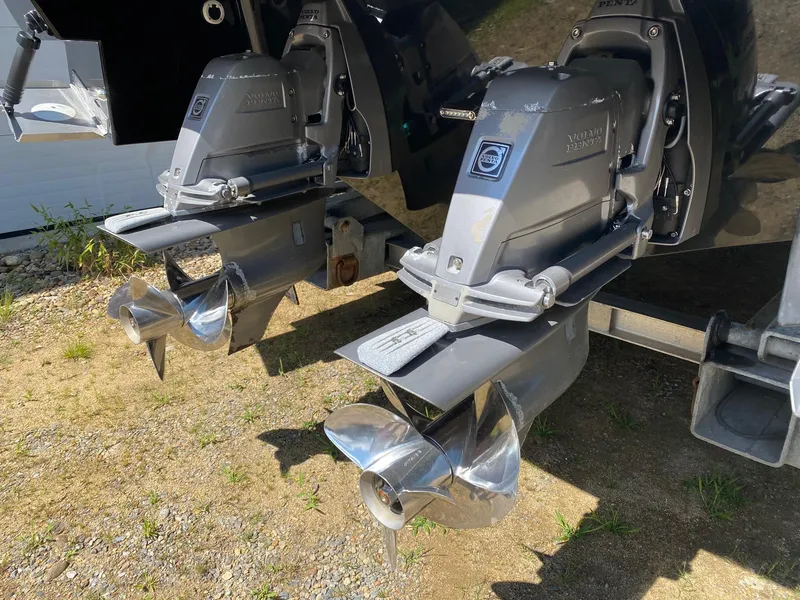 Slide: The Image of Twin outboard motors on a 2013 Regal 3200 Bowrider, showcasing propellers. - 4