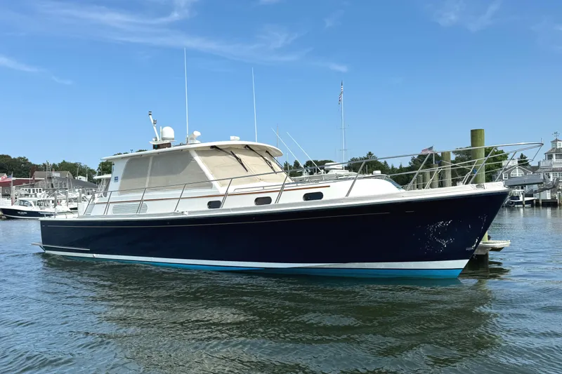 Slide: The Image of 2009 Grand Banks 45 Eastbay SX yacht on calm water, under clear blue sky. - 0