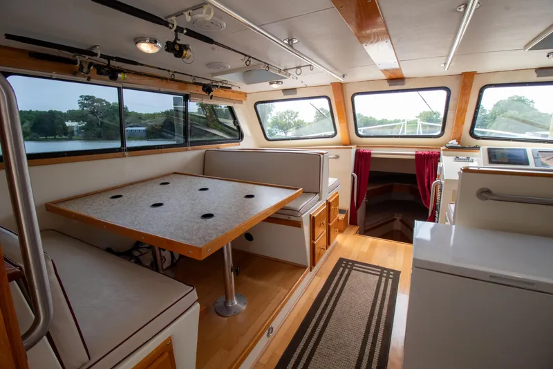 Slide: The Image of Interior of 2008 Chesapeake 48 Deadrise boat with dining area and windows. - 10