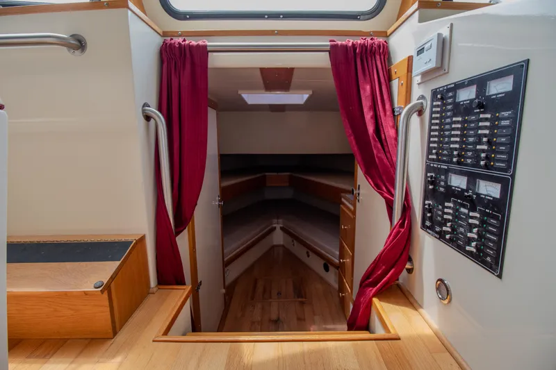 Slide: The Image of Interior of 2008 Chesapeake 48 Deadrise boat with red curtains and control panel. - 11