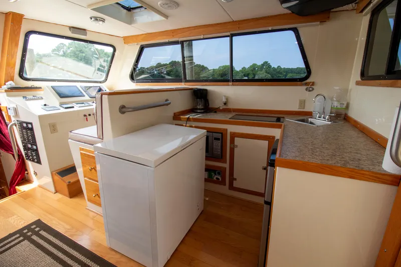 Slide: The Image of Interior of 2008 Chesapeake 48 Deadrise boat with kitchen and navigation area. - 12