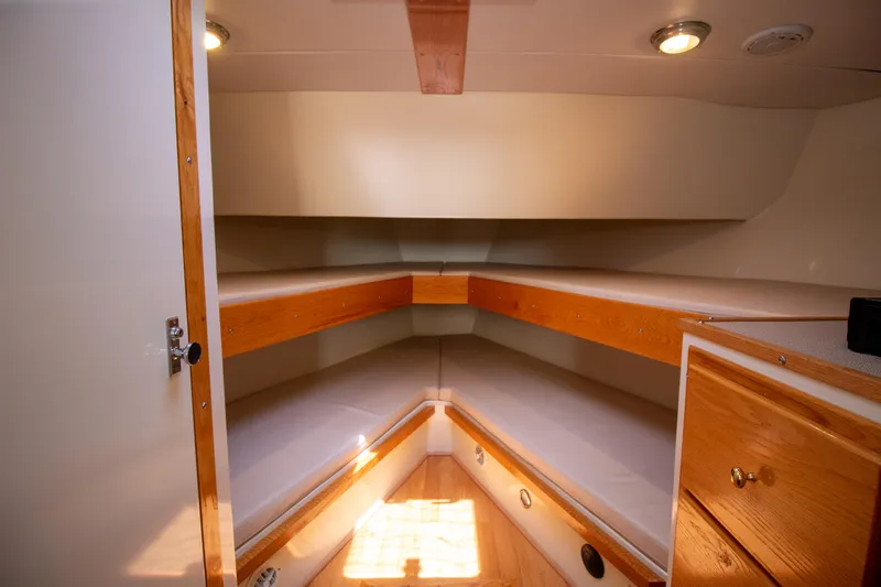 Slide: The Image of Cozy cabin interior of 2008 Chesapeake 48 Deadrise boat with wooden accents and lighting. - 13