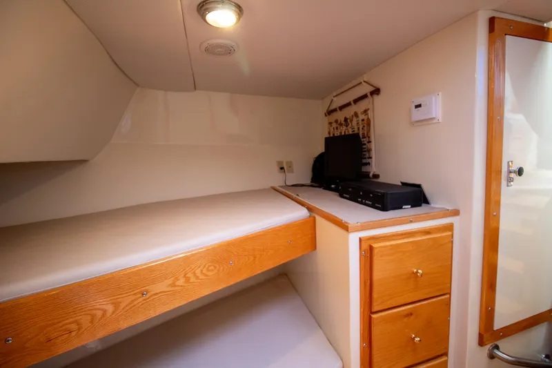 Slide: The Image of Cozy cabin interior of 2008 Chesapeake 48 Deadrise with bed and wooden storage. - 14