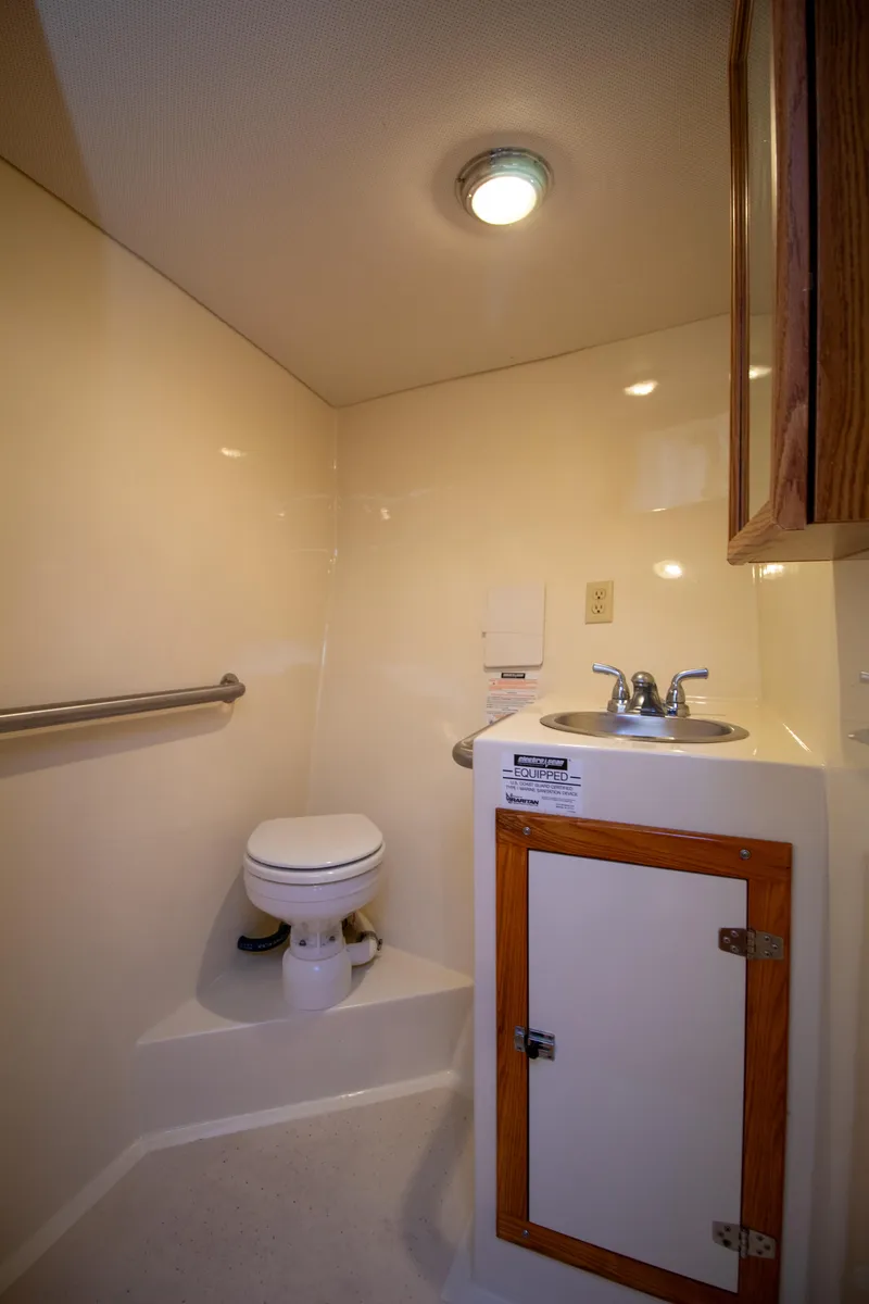 Slide: The Image of Compact bathroom in 2008 Chesapeake 48 Deadrise boat with sink and toilet. - 15