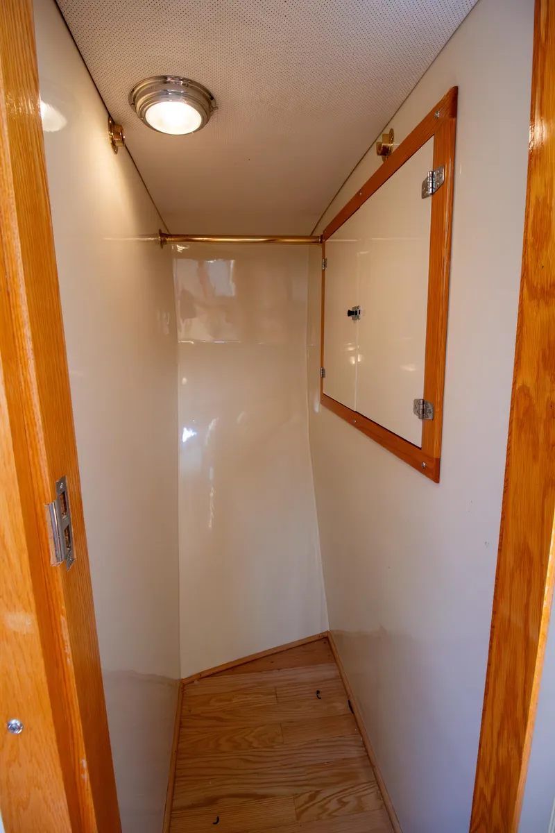Slide: The Image of Narrow interior space of 2008 Chesapeake 48 Deadrise boat with wooden accents. - 16