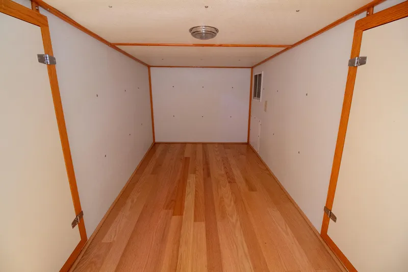 Slide: The Image of Interior cabin of 2008 Chesapeake 48 Deadrise boat with wood flooring and white walls. - 17
