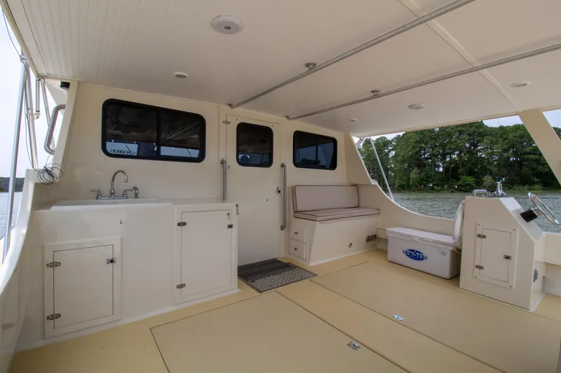 Slide: The Image of Spacious deck of 2008 Chesapeake 48 Deadrise boat with seating and storage. - 18
