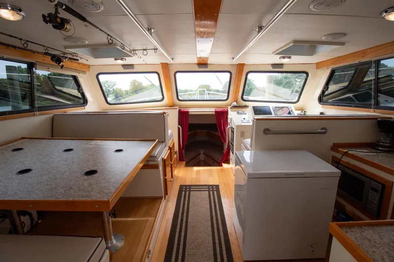 Slide: The Image of Interior of 2008 Chesapeake 48 Deadrise boat with dining area and navigation station. - 2