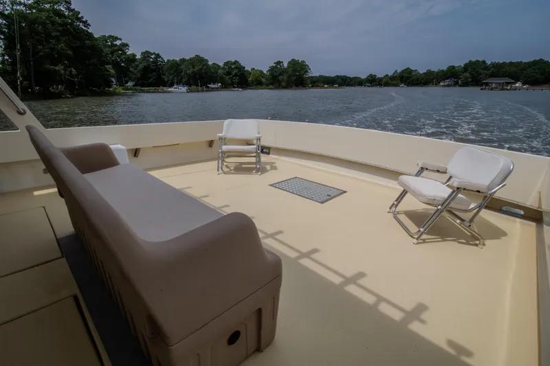 Slide: The Image of Chesapeake 48 Deadrise 2008 boat deck with chairs on a calm river. - 22