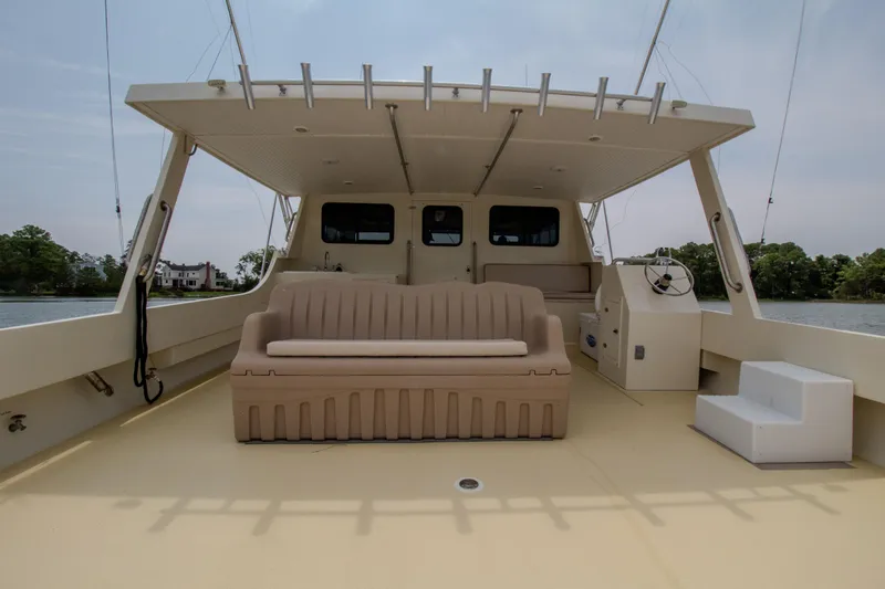 Slide: The Image of Chesapeake 48 Deadrise 2008 boat interior with seating and helm, docked on calm water. - 23