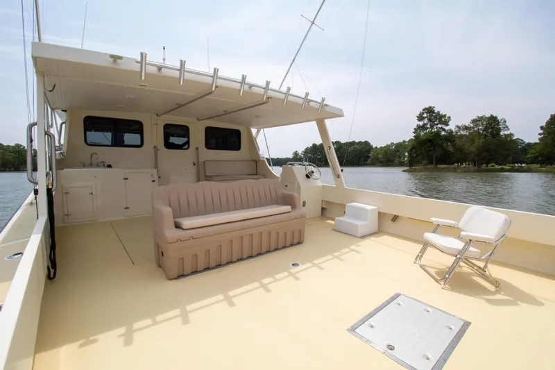 Slide: The Image of Spacious deck of 2008 Chesapeake 48 Deadrise boat with seating, overlooking serene waters. - 24