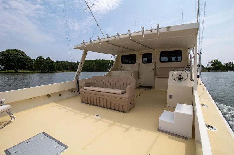 Slide: The Image of 2008 Chesapeake 48 Deadrise boat with spacious deck and seating on calm water. - 25