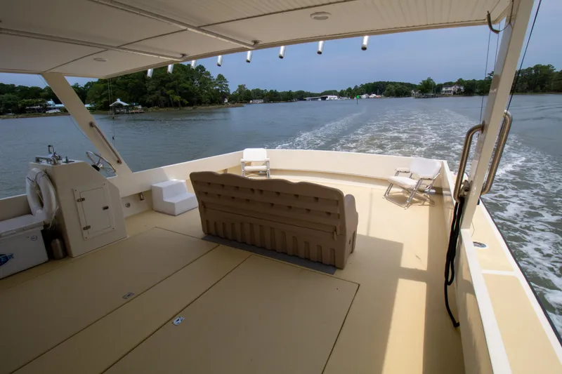 Slide: The Image of 2008 Chesapeake 48 Deadrise boat interior with seating, cruising on a calm river. - 29