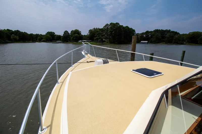 Slide: The Image of Chesapeake 48 Deadrise 2008 boat deck on calm water, surrounded by lush greenery. - 32