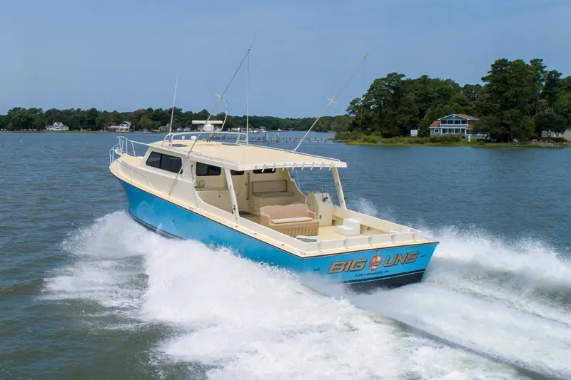Slide: The Image of Chesapeake 48 Deadrise boat cruising on water, 2008 model, blue and white design. - 36