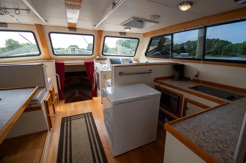 Slide: The Image of Interior of 2008 Chesapeake 48 Deadrise boat with kitchen and seating area. - 6