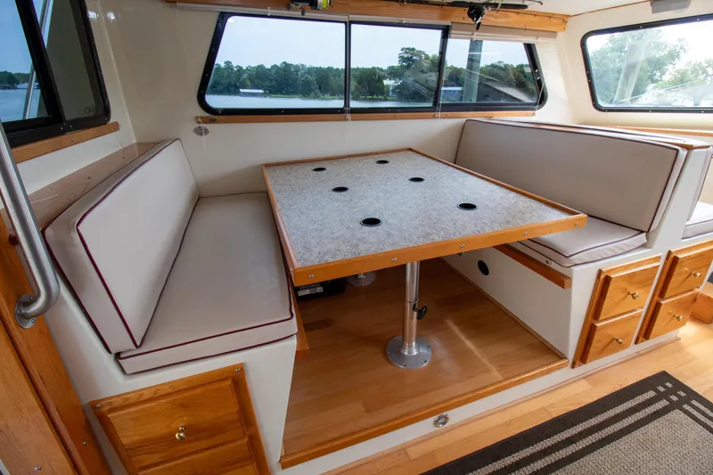 Slide: The Image of Interior of 2008 Chesapeake 48 Deadrise boat with dining area and cushioned seating. - 9