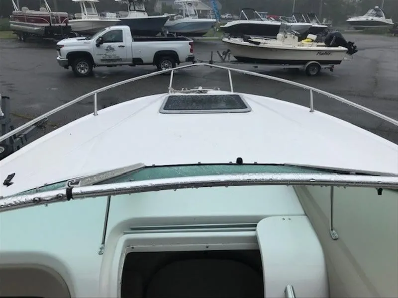 Slide: The Image of 2001 Chaparral 235 SSi boat on trailer, surrounded by other boats and a truck. - 12