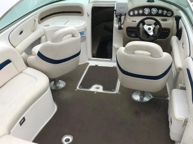 Slide: The Image of 2001 Chaparral 235 SSi boat interior with beige seating and steering console. - 15