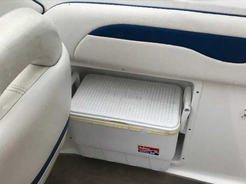 Slide: The Image of White Igloo cooler stored on a 2001 Chaparral 235 SSi boat interior. - 16