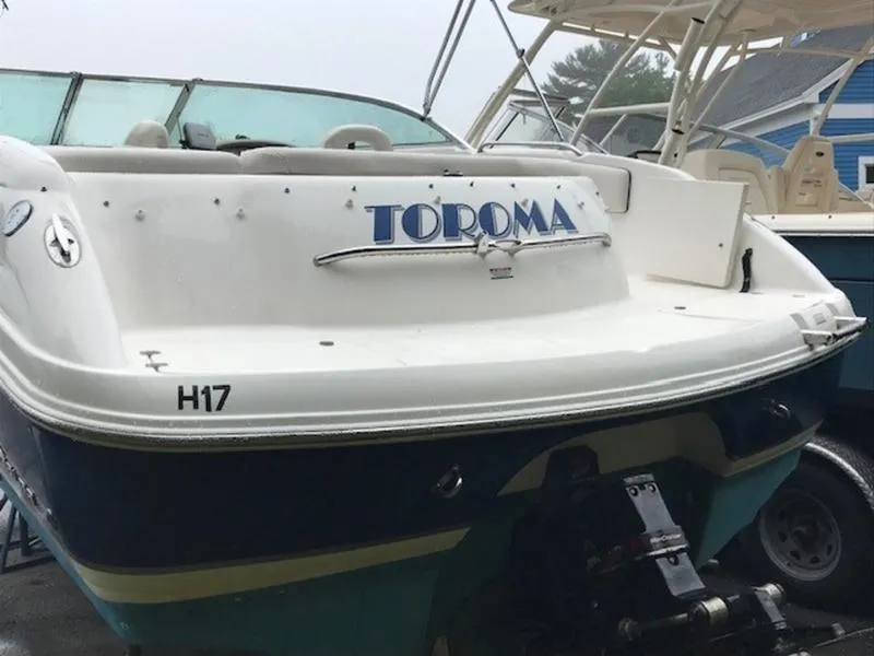 Slide: The Image of 2001 Chaparral 235 SSi boat with "TOROMA" name on the stern, docked outdoors. - 4