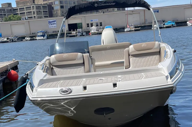 Slide: The Image of 2020 Crownline E 205 XS boat docked at marina, featuring sleek design and comfortable seating. - 12