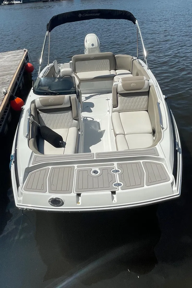 Slide: The Image of 2020 Crownline E 205 XS boat with spacious seating on the water. - 14