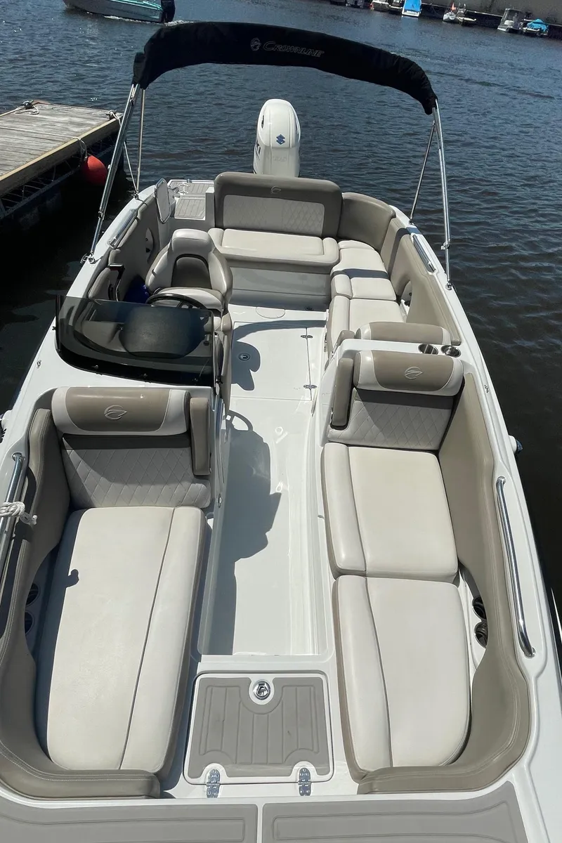 Slide: The Image of 2020 Crownline E 205 XS boat with spacious seating on the water. - 16