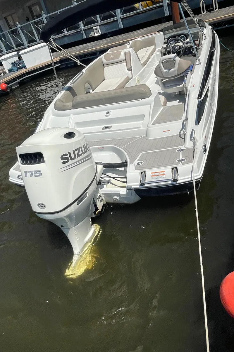 Slide: The Image of 2020 Crownline E 205 XS boat with Suzuki 175 engine docked in marina. - 17