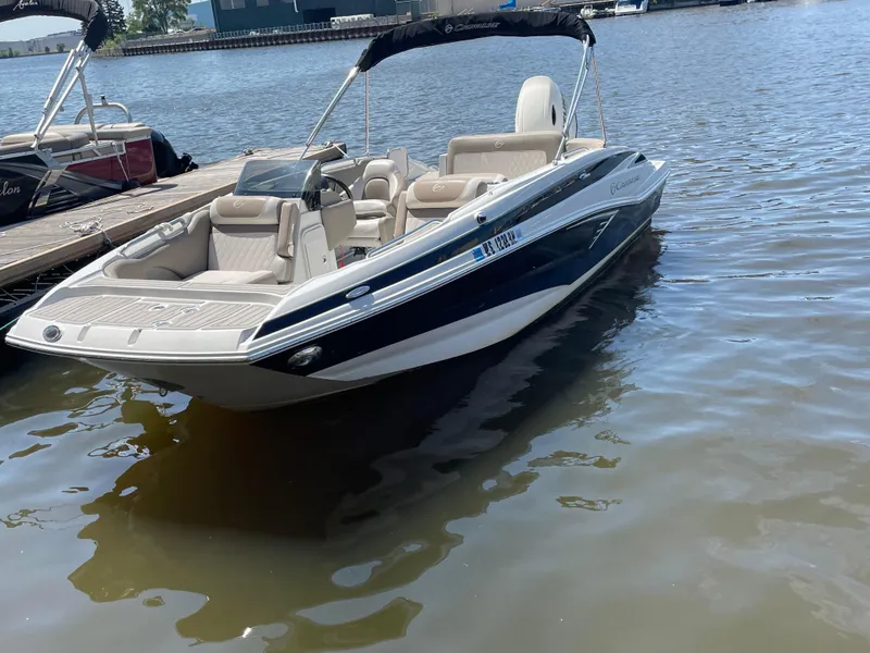 Slide: The Image of 2020 Crownline E 205 XS boat docked on calm water. - 5