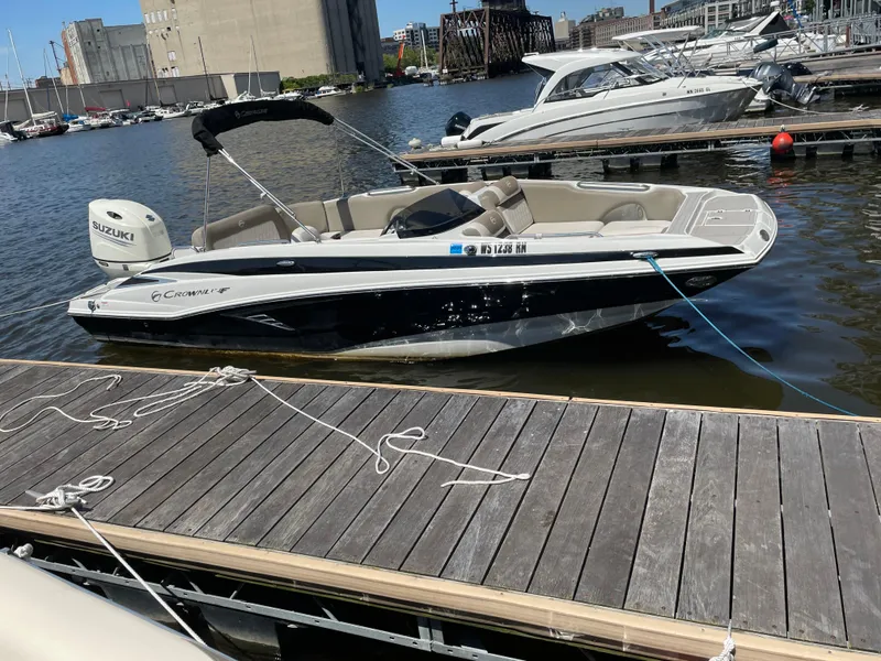 Slide: The Image of 2020 Crownline E 205 XS boat docked at marina with Suzuki engine. - 6