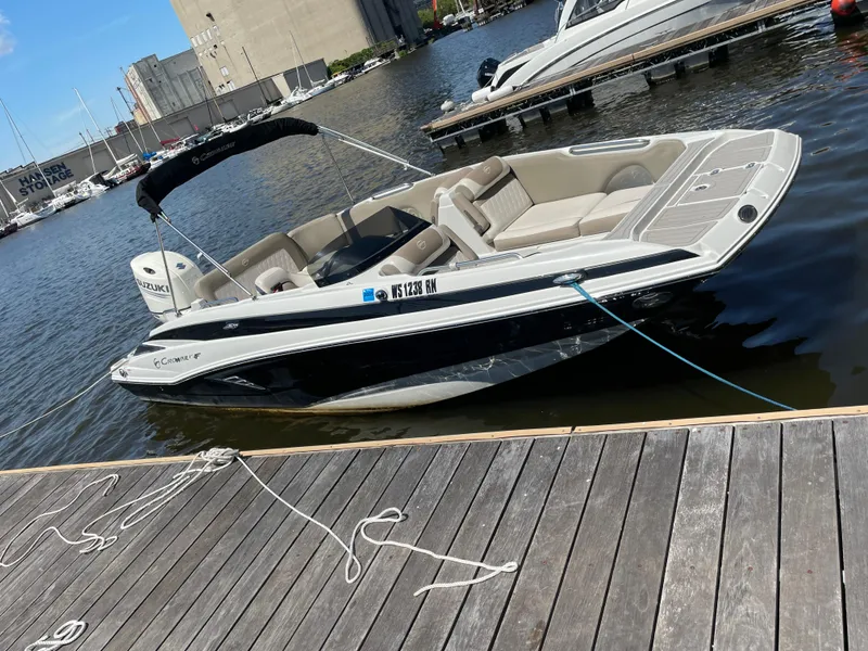 Slide: The Image of 2020 Crownline E 205 XS boat docked at marina, sunny day. - 7